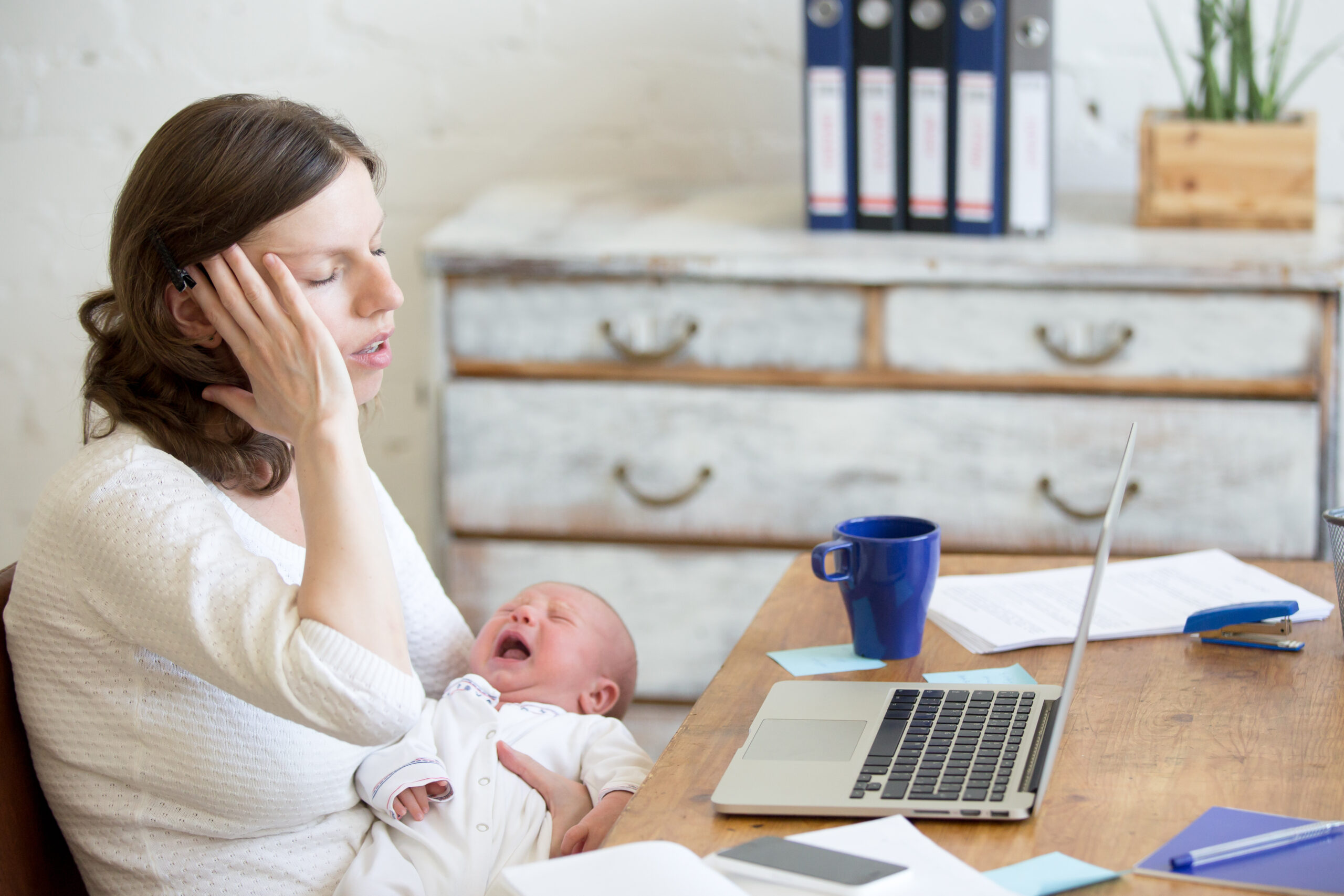 crying baby with mother