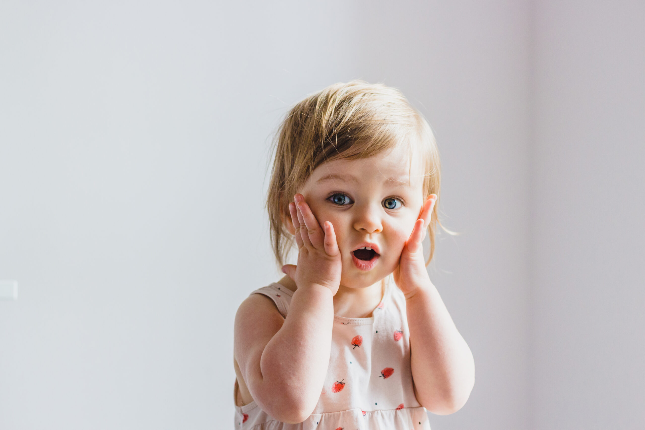 Surprised,Shocked,Child,Toddler,Girl,With,Hands,On,Her,Cheeks Baby Awake and Smiling