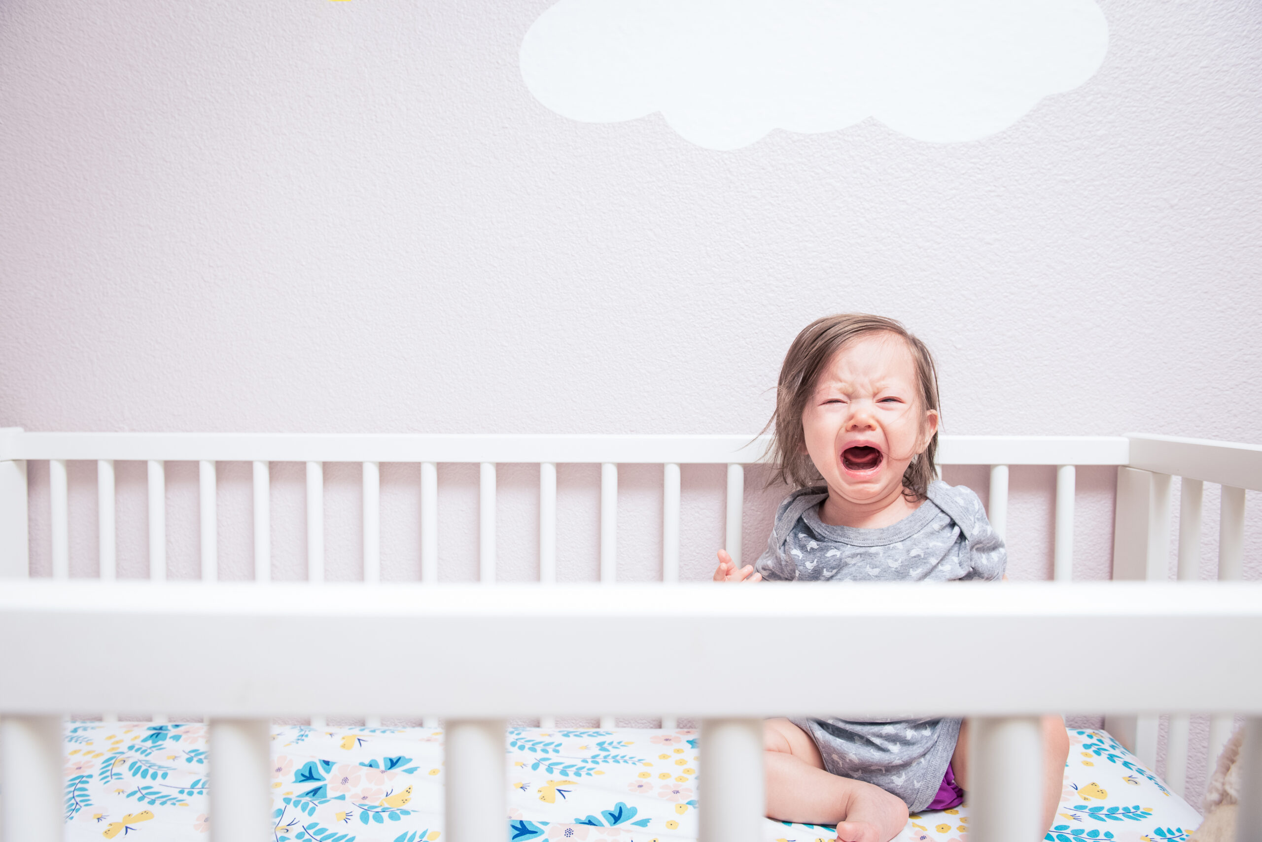 A baby crying in her crib