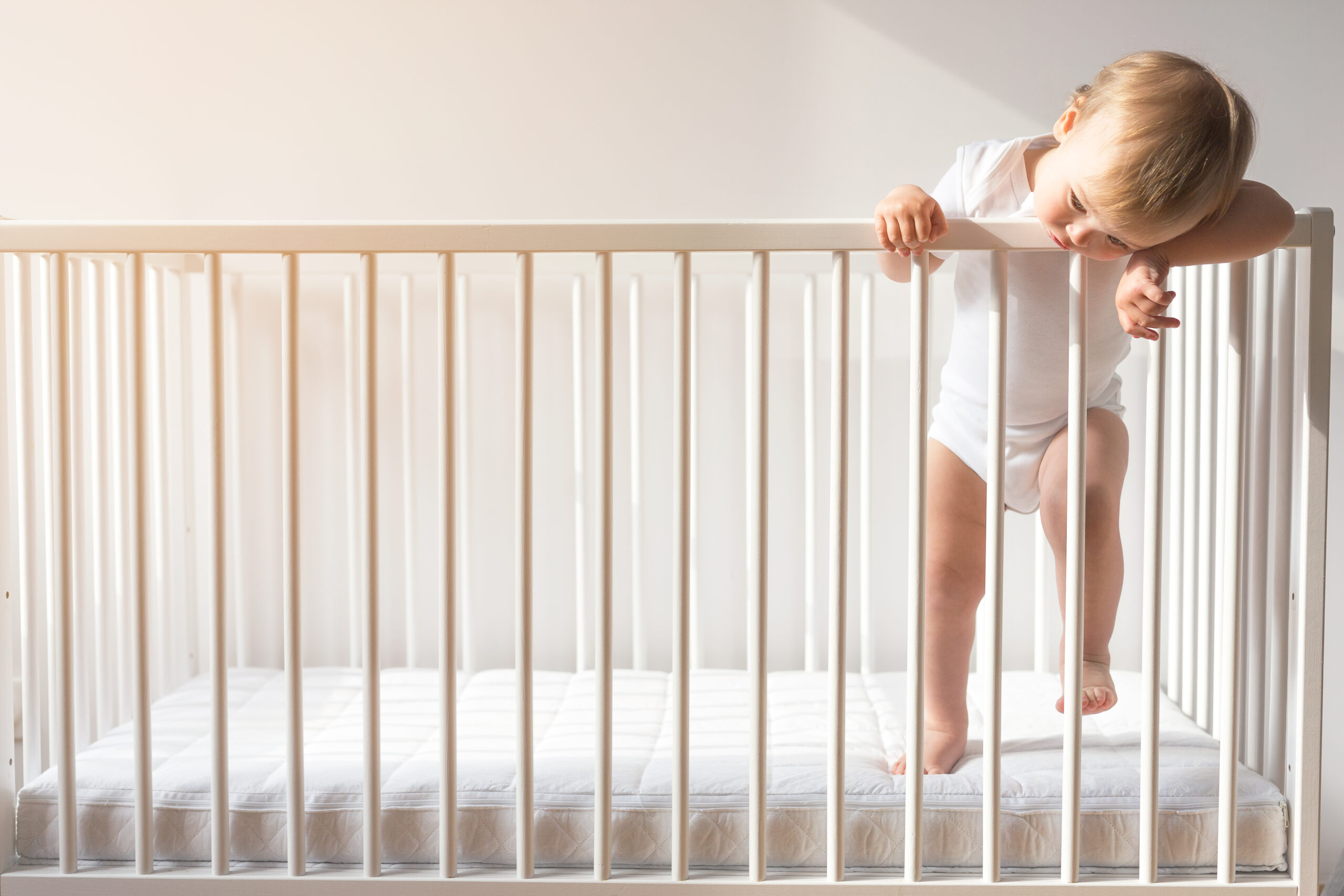 Portrait,Of,Bored,Baby,Standing,In,Crib.,Baby,Boy,Stand
