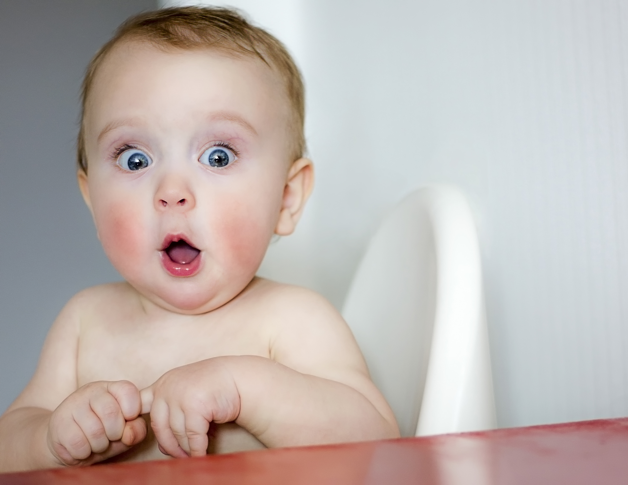 Surprised,Kid,Sitting,At,Table.,Child's,Eyes,Widened,And,Mouth