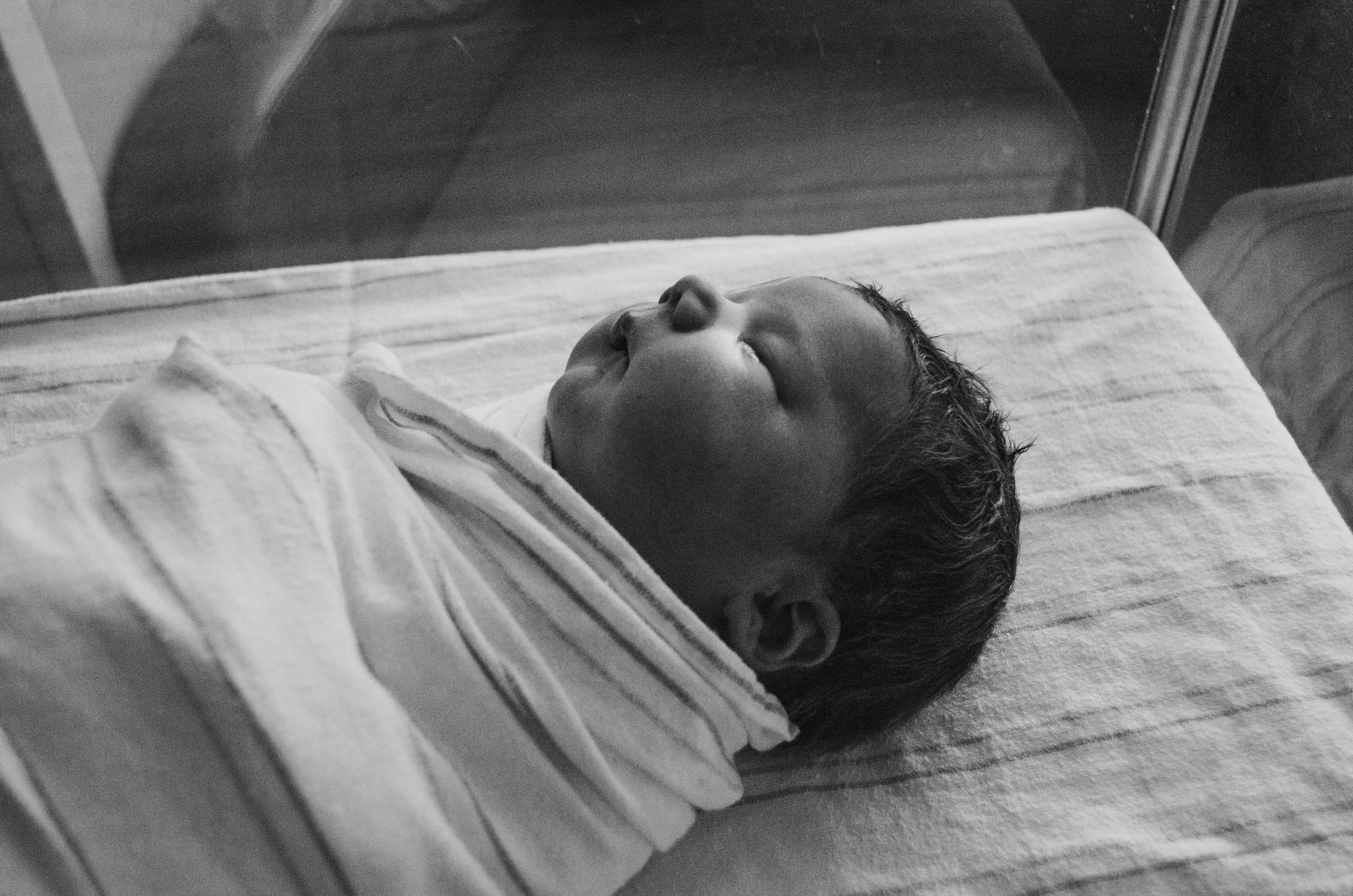 swaddled newborn baby asleep