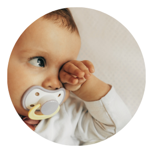 research backed baby with soother rubbing eye - plume sleep consulting