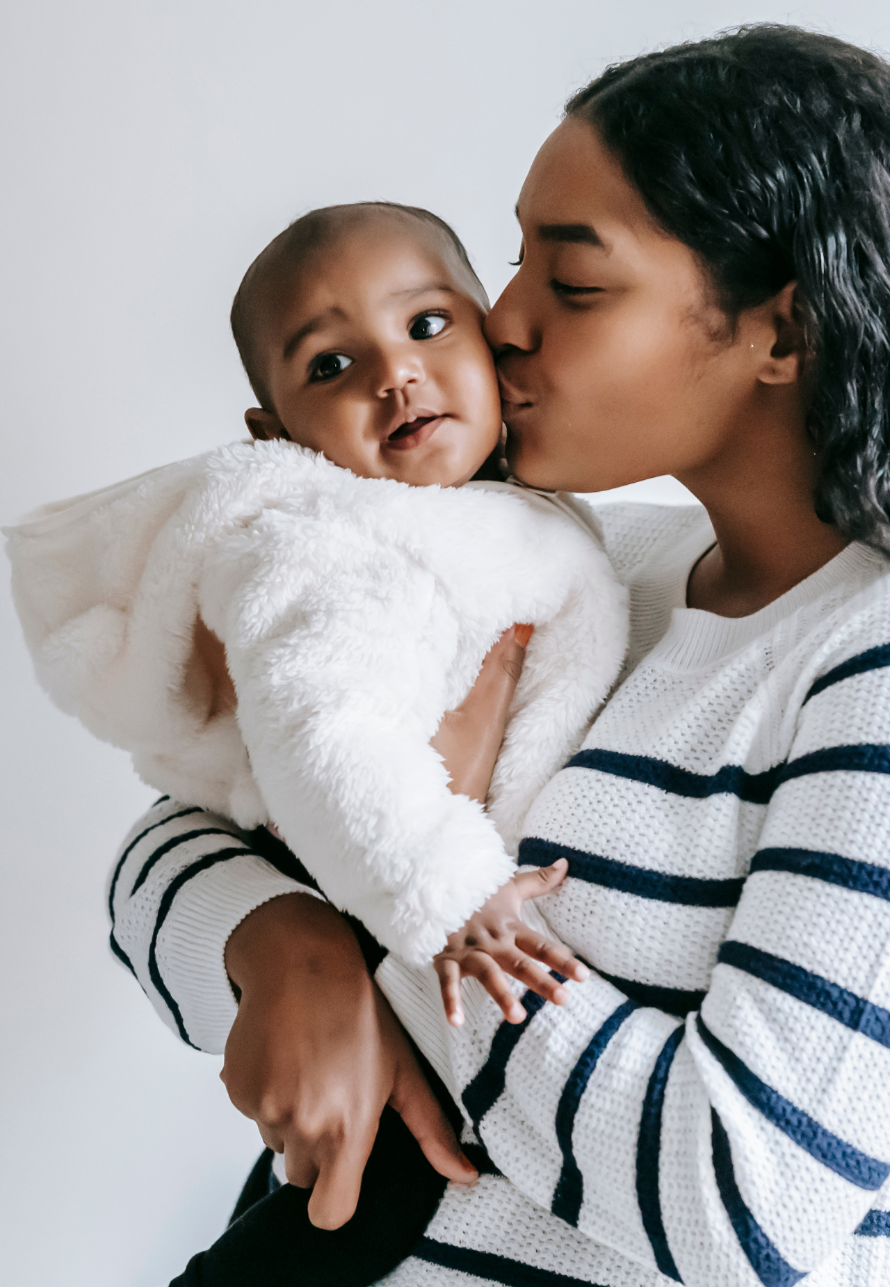 woman kissing baby